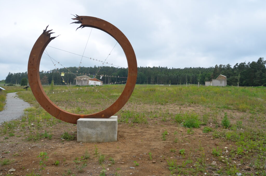 Katharsis - kovový symbolický kruh, násilně roztržený. Místo pro vzkazy návštěvníků.